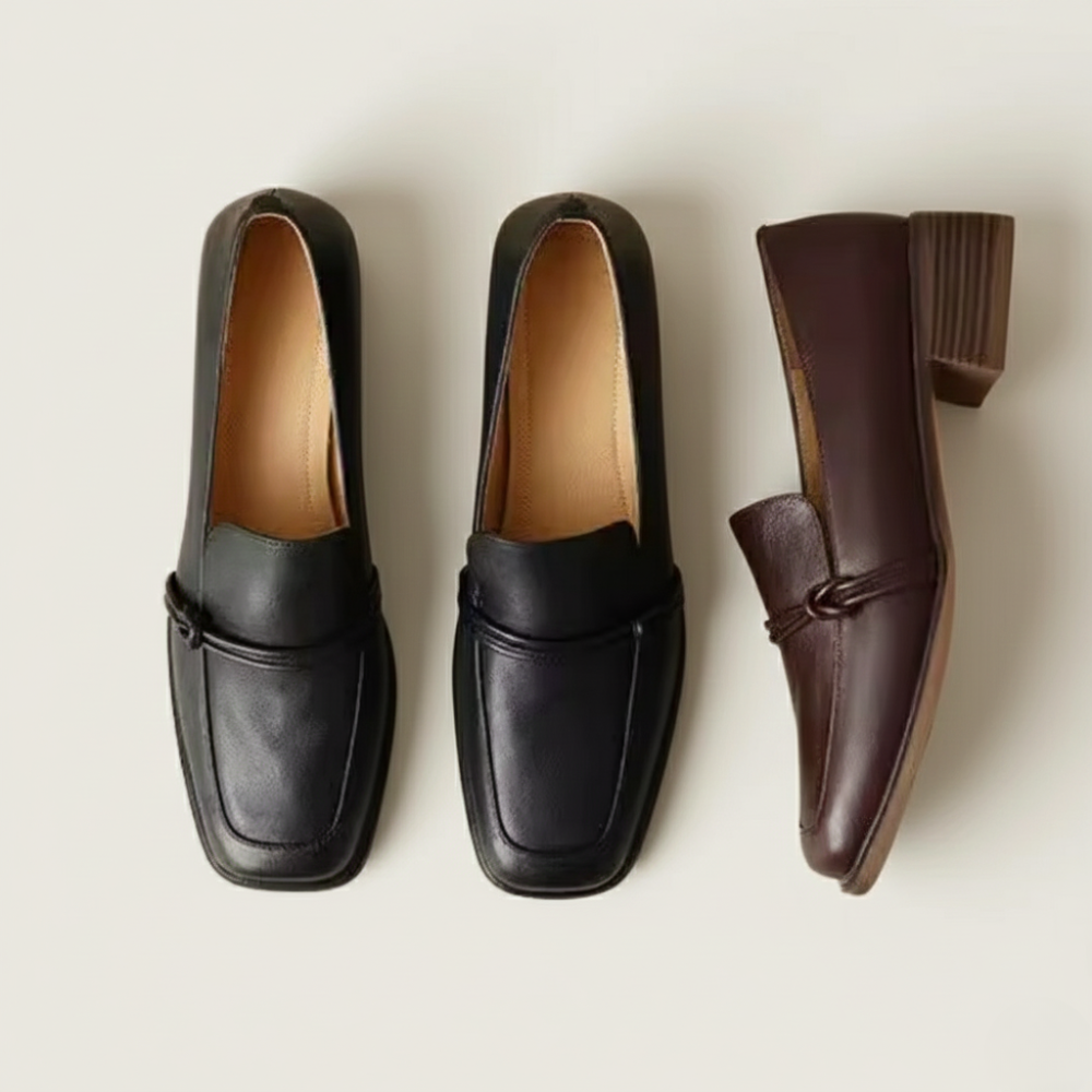 Two pairs of black loafers and one brown loafer on a light beige background
